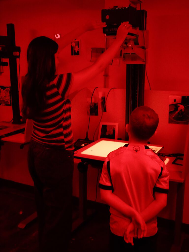 Emily helping Ellis set up his enlarger in the darkroom